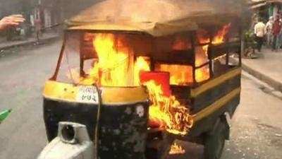 A vehicle is set alight during protests