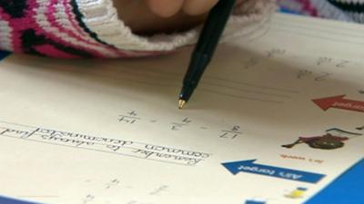 School child completing a maths paper