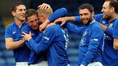 Glenavon players celebrate their 7-0 victory over Ballymena United