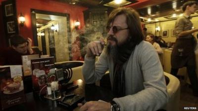 A man smoking a cigarette in a cafe in Siberia