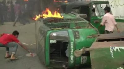 A vehicle on its side and on fire