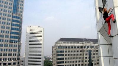 Alain Robert scales the 27-storey high building