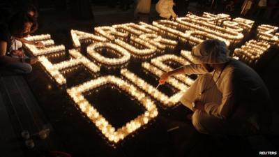 Emiratis light candles to mark Earth Hour near Burj Khalifa in Dubai