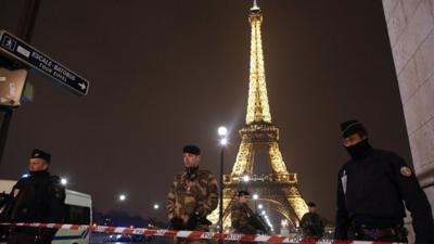 French police stand guard near the Eiffel Tower in Paris