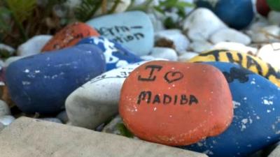A well-wisher's stone left in front of Mandela's house