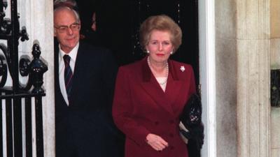 Margaret Thatcher, watched by husband Denis, at 10 Downing Street, London, before leaving for Buckingham Palace to offer resignation