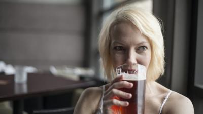 Woman drinking a pint of beer