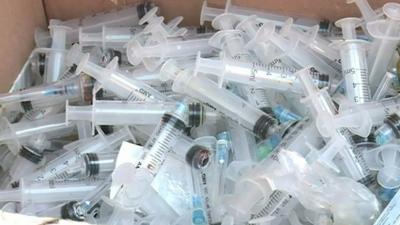 Used plastic syringes