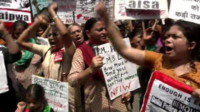 Women protesters with signs in Delhi