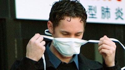 A man dons a mask in Toronto during a Sars outbreak in 2003