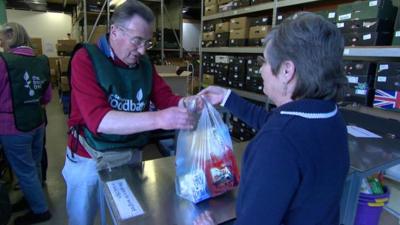 Woman donating to food bank