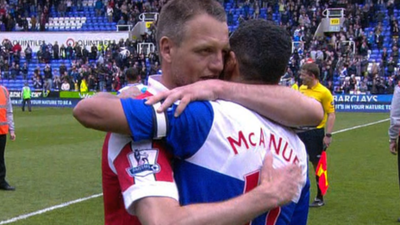 QPR's Clint Hill and Reading's Jobi McAnuff embrace at the final whistle