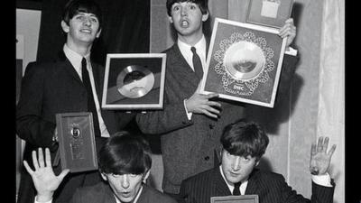 The Beatles pictured with silver discs in 1963