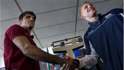 Iranian and US wrestlers shake hands