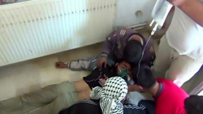 A still from amateur footage shows a man treated by doctors in Saraqeb, Syria, where it is alleged canisters containing poisonous gas were dropped