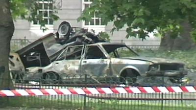 A burnt out car from the aftermath of a bomb in Hyde Park
