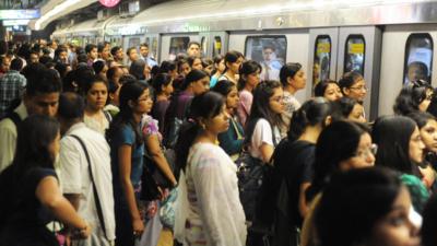 Passengers wait to get onto the Delhi Metro