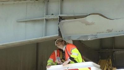 Engineers examine the damage to the A12 bridge near Kelvedon