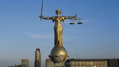 Statue of the Scales of Justice on the rooftop of the Old Bailey building