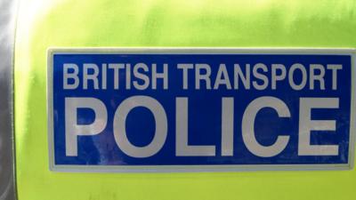 Close-up of British Transport Police logo on the jacket of a police officer