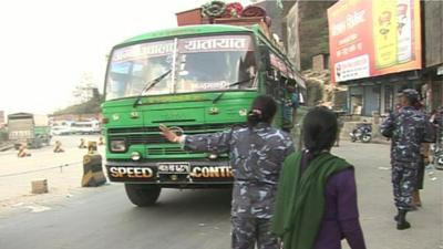 A coach being stopped so it can be searched