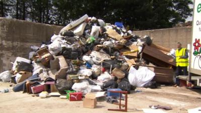 Rubbish piled high after collection