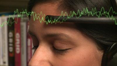 Sumi Dais wearing a headset that can monitor brainwaves