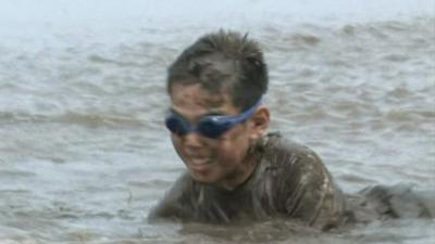 Child playing in mud in Ono City in Japan