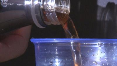 Caffeine drink being poured into glass