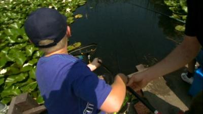 A young boy learns how to fish