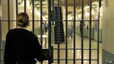 A prison officer locks a door at Wormwood Scrubs