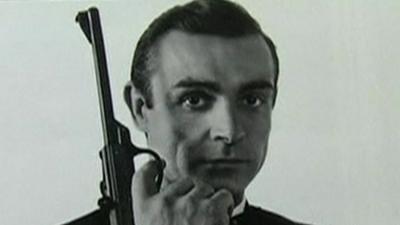 Sean Connery holds pistol in James Bond poster