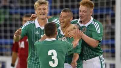 Northern Ireland players celebrate victory over Denmark