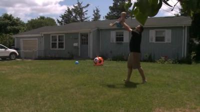 Man with child outside New Jersey home