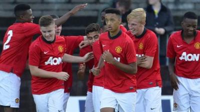 Manchester United celebrate victory over Strikers FC at the Milk Cup