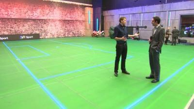 Jake Humphrey shows David Bond around the news tudio for BT Sport