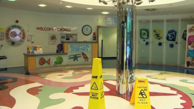 Ward reception with wet floor notices