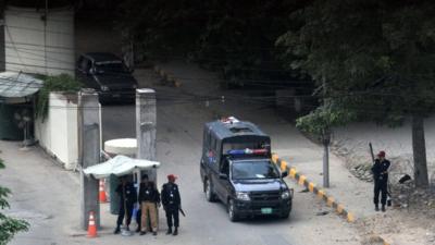 Security guards and police officers outside the US consulate in Lahore