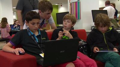 Children working on computers and tablets