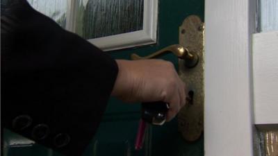 A front door being unlocked