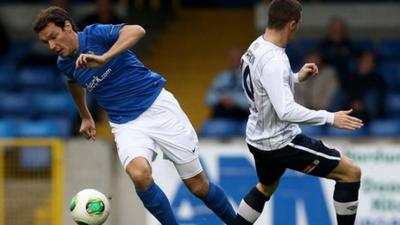 Kyle Neill of Glenavon in action against Ruairi Harkin of Coleraine