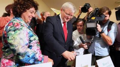Australian Prime Miniter Kevin Rudd casts his vote with his wife Therese Rein at a polling station in Brisbane