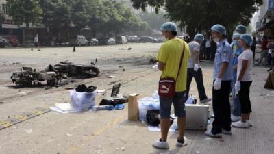 Investigators go through the site of an explosion outside Balijie Primary School in Lingchuan county in south China"s Guangxi Zhuang