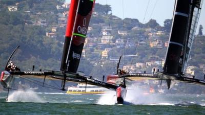 Team New Zealand (l) and Oracle Team USA contest America's Cup