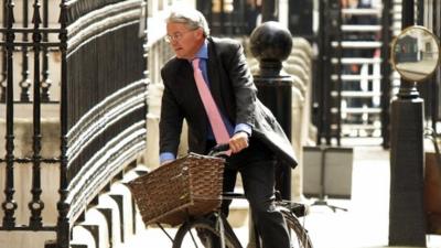 File photo of Andrew Mitchell riding his bike in 2011