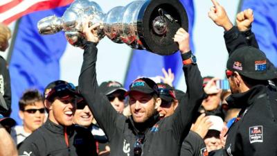 Ben Ainslie lifts the America's Cup trophy