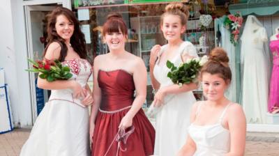 PDSA volunteers model some of the donated dresses