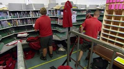 Royal Mail staff in sorting office