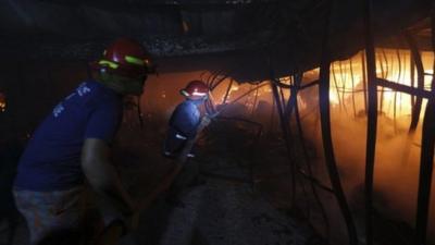 Firefighters try to control a fire inside a garment factory in the Bangladeshi town of Gazipur