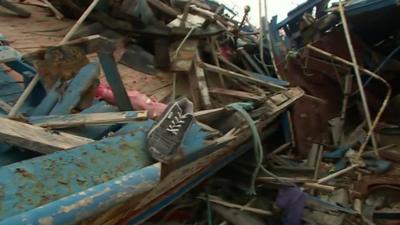 Wrecked boats lie in Lampedusa port